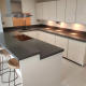 Gloss Cream Kitchen with Grey Solid Surface Worktops